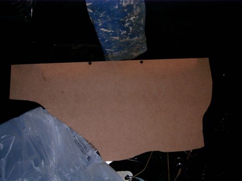 1978 Ford Mustang II - A brown cardboard panel is shown against a dark background with some blue material and plastic sheeting.