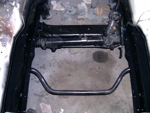 1978 Ford Mustang II - Close-up view of a rack and pinion steering assembly and sway bar, likely during restoration or repair.