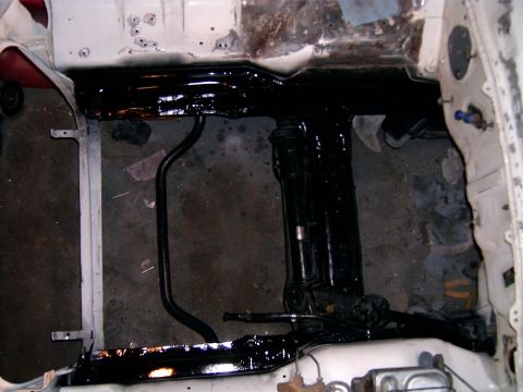 1978 Ford Mustang II - Underside of a car frame showing suspension components after being painted black.