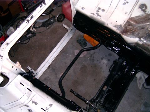 1978 Ford Mustang II - The chassis of a 1978 Ford Mustang II is visible, undergoing restoration with new paint and suspension parts.