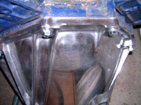 1978 Ford Mustang II - Close-up view of an engine component, showing bolted metal sections and blue painted areas.