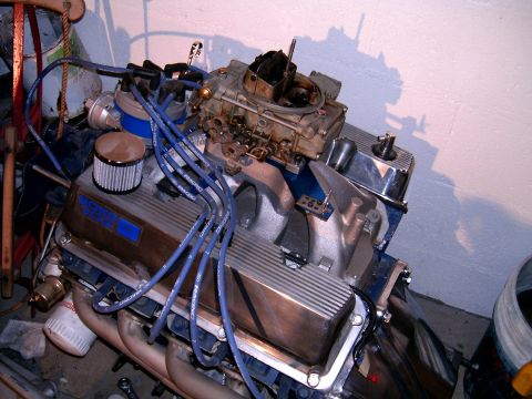 1978 Ford Mustang II - A close-up view of a V8 engine, chrome valve covers and blue spark plug wires.