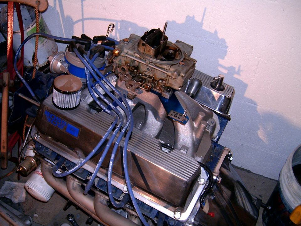 Engine with blue spark plug wires and a carburetor