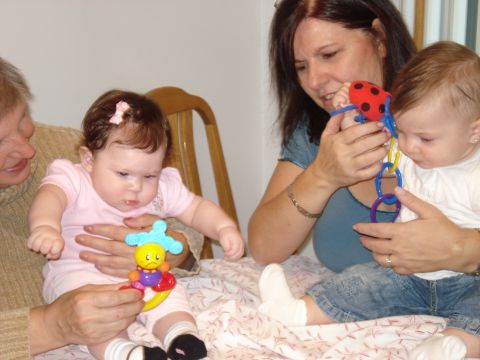 2000 Ford Crown Victoria - Two babies and two adults share a moment of play and interaction.