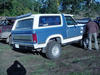1985 Ford Bronco - This blue and white SUV features a lifted suspension and appears to be from the early 1980s.