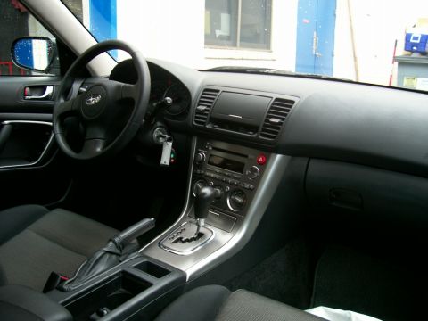 2001 Ford Crown Victoria - The interior of a Subaru Legacy shows the driver's side dashboard and center console.