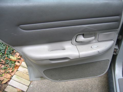 1996 Ford Crown Victoria - Interior view of a car door panel, showing the armrest, handle, and controls.