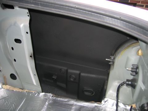 1996 Ford Crown Victoria - The interior of a vehicle's trunk, showing sound deadening material and bare metal panels.
