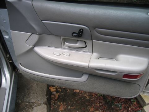 1996 Ford Crown Victoria - Close-up of a car's interior door panel, showing the window controls and seat adjustment buttons.