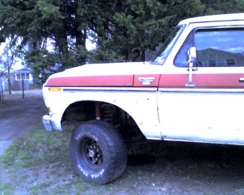 1978 Ford Bronco - Side view of a 1978 Ford Bronco with a red stripe on the body.