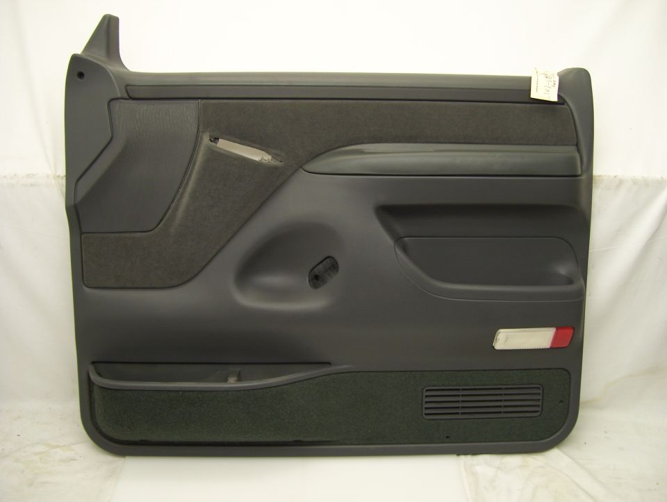 Dark gray door panel with speaker grille and reflector