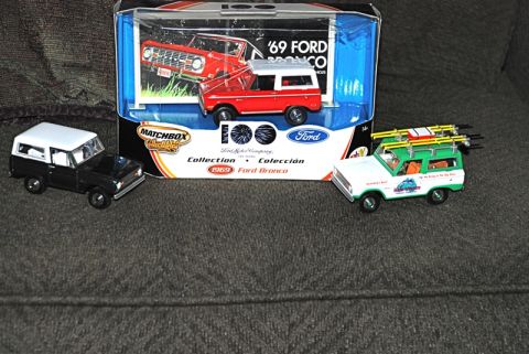 1996 Ford Bronco - Three Matchbox Ford Bronco toy vehicles are displayed, one in its original packaging.