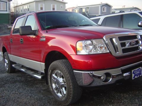1986 Ford F-150 - This red Ford F-150 truck is shown from a 3/4 front angle, with its model year appearing to be 2004 based on its body style.