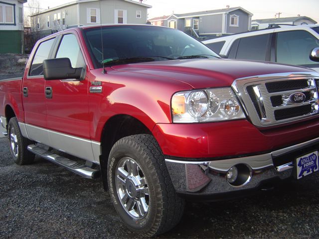 Red Ford F-150 truck, 3/4 front view. Year is 2004