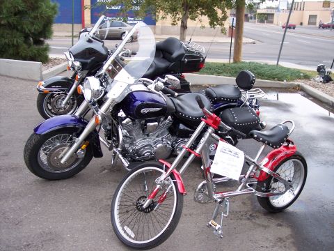 1972 Ford Ranchero - Two motorcycles and a custom bicycle are parked together on pavement.