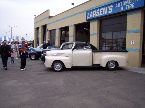 1972 Ford Ranchero - A cream and green pickup truck is parked in front of Larsen's Automotive & Tire.