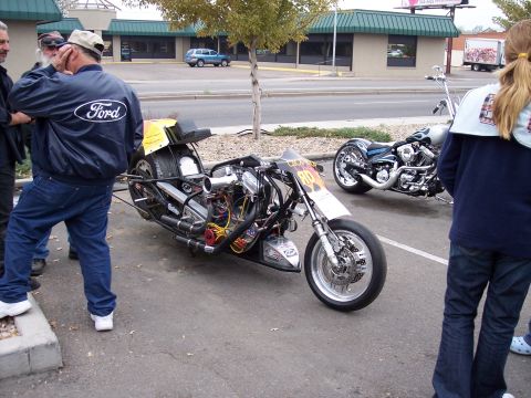 1972 Ford Ranchero - Custom drag motorcycle parked at a show, with another motorcycle behind it.