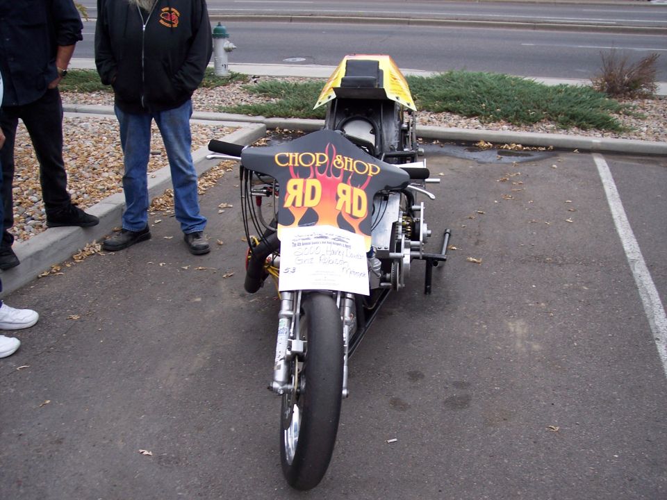 Front view of a drag racing motorcycle with 'CHOP SHOP RD RD' graphics