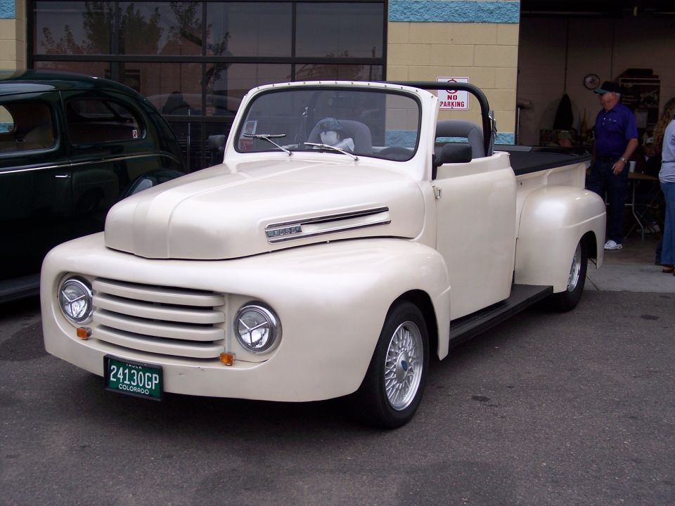 Cream convertible pickup truck with a Colorado license plate