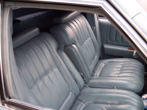 1972 Ford Ranchero - Interior view of a vehicle light blue leather bucket seats and a center console.