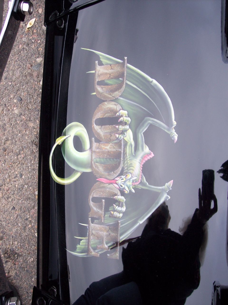 Black hood with airbrushed dragon and text 'Dodge'