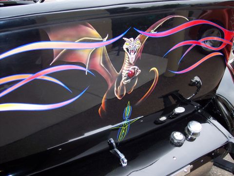 1972 Ford Ranchero - A custom airbrushed dragon with flames adorns the side of a black vehicle.