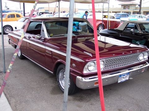 1972 Ford Ranchero - A maroon 1964 Ford Ranchero is parked at an outdoor event with other vehicles visible.