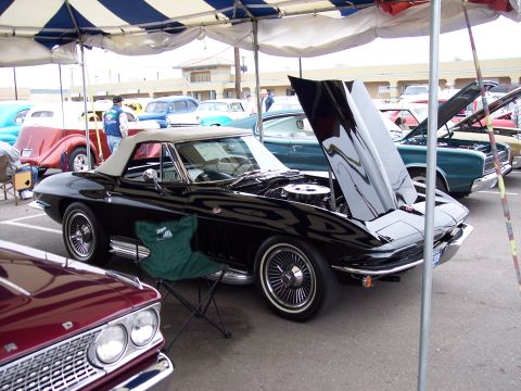 1972 Ford Ranchero - Black convertible with hood open at a car show, other vehicles present.