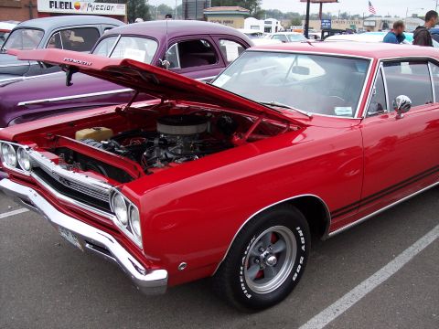 1972 Ford Ranchero - Red muscle car with hood open, parked next to a purple car.