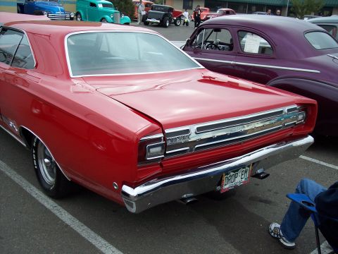 1972 Ford Ranchero - A red 1969 Plymouth Road Runner is parked next to a purple vintage car.