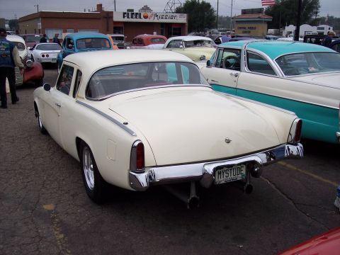 1972 Ford Ranchero - Rear view of a 1955 Studebaker coupe, showing its distinctive tail fins and custom exhaust pipes.