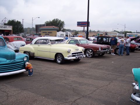 1972 Ford Ranchero - Several classic cars are gathered at an outdoor event under a cloudy sky.