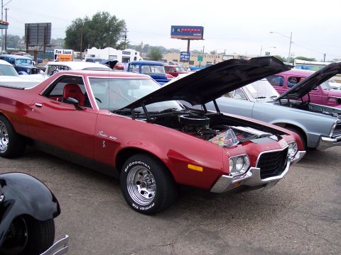 1972 Ford Ranchero - A red 1972 Ford Ranchero is displayed with its hood open at a car show.