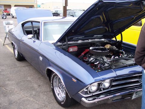 1972 Ford Ranchero - Blue muscle car with hood open, displaying its engine and chrome wheels.