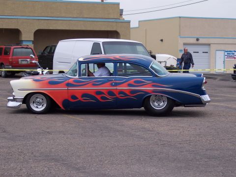 1972 Ford Ranchero - A customized classic car with a distinctive flame paint job is parked in a lot.