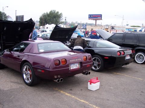 1972 Ford Ranchero - Two Corvettes are parked with hoods open at an outdoor event.