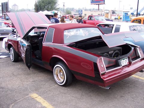 1972 Ford Ranchero - Customized coupe with aftermarket stereo and unique paint details. Multiple vehicles visible in background.