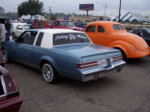 1972 Ford Ranchero - A blue coupe with a white vinyl roof and custom lettering on the rear window is parked at an outdoor event.