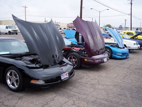 1972 Ford Ranchero - A line of Corvettes, hoods up, are displayed at an outdoor event.