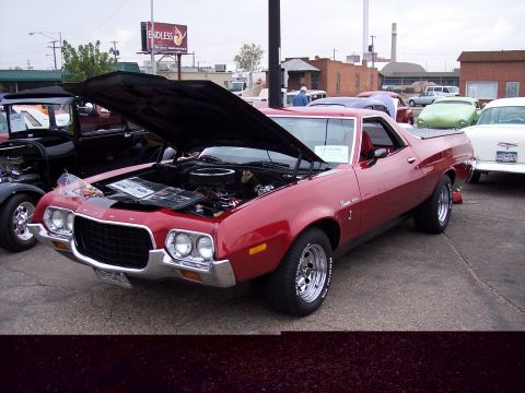 1972 Ford Ranchero - A red 1972 Ford Ranchero is displayed with its hood open, parked at an outdoor event.