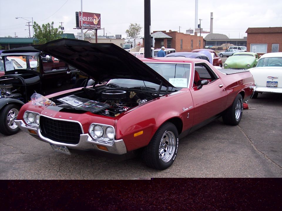 Red 1972 Ford Ranchero with hood open, parked next to other vehicles