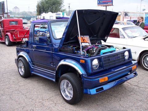 1972 Ford Ranchero - Modified Suzuki Samurai for sale at a car show, with other vehicles visible.