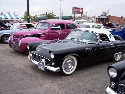 1972 Ford Ranchero - A black 1957 Ford Thunderbird hardtop coupe is parked next to other classic vehicles at a show.