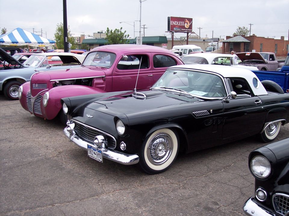 Black 1957 Ford Thunderbird hardtop coupe with white roof and whitewall tires