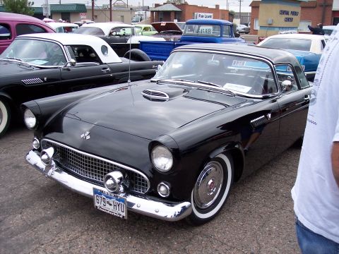 1972 Ford Ranchero - Black 1955 Ford Thunderbird parked at a car show with other vehicles visible.