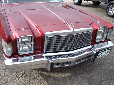 1972 Ford Ranchero - Front view of a red car with a prominent chrome grille and dual headlights. The license plate is visible.