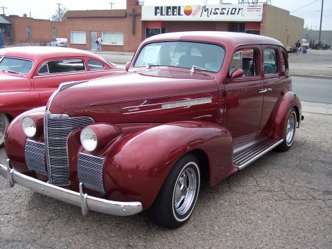 1972 Ford Ranchero - A maroon sedan from the late 1930s is parked next to another vehicle.