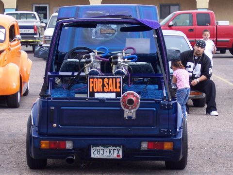 1972 Ford Ranchero - A modified blue Suzuki Samurai is parked with a "FOR SALE" sign visible in the rear, custom interior work and hydraulics.