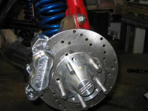 1992 Ford Mustang - This is a close-up view of a vehicle's brake system, a drilled rotor and a polished caliper.