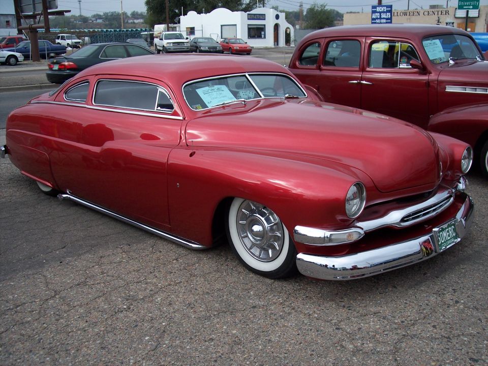 Red custom coupe with whitewall tires and chrome grille
